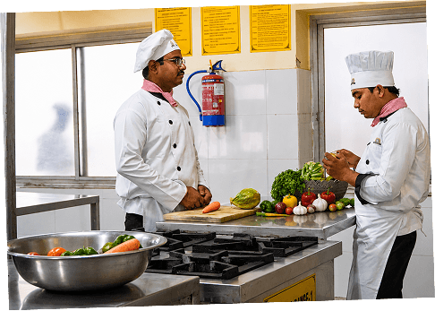 Chefs preparing food at a stainless-steel counter