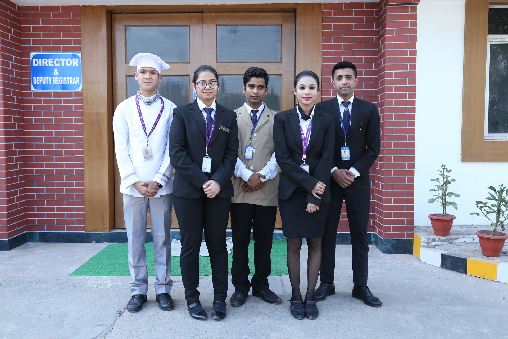 Students and faculty posing in a dining area