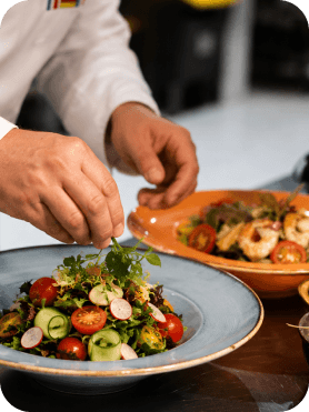 Chef plating a fresh salad