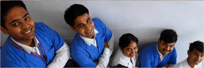 Students in blue uniforms at a campus event