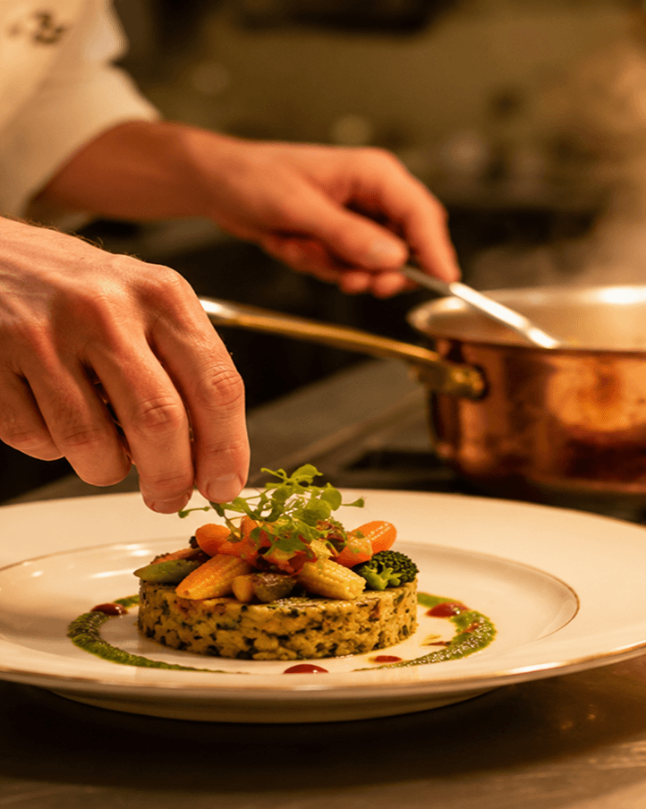Chef plating a dish in the production kitchen
