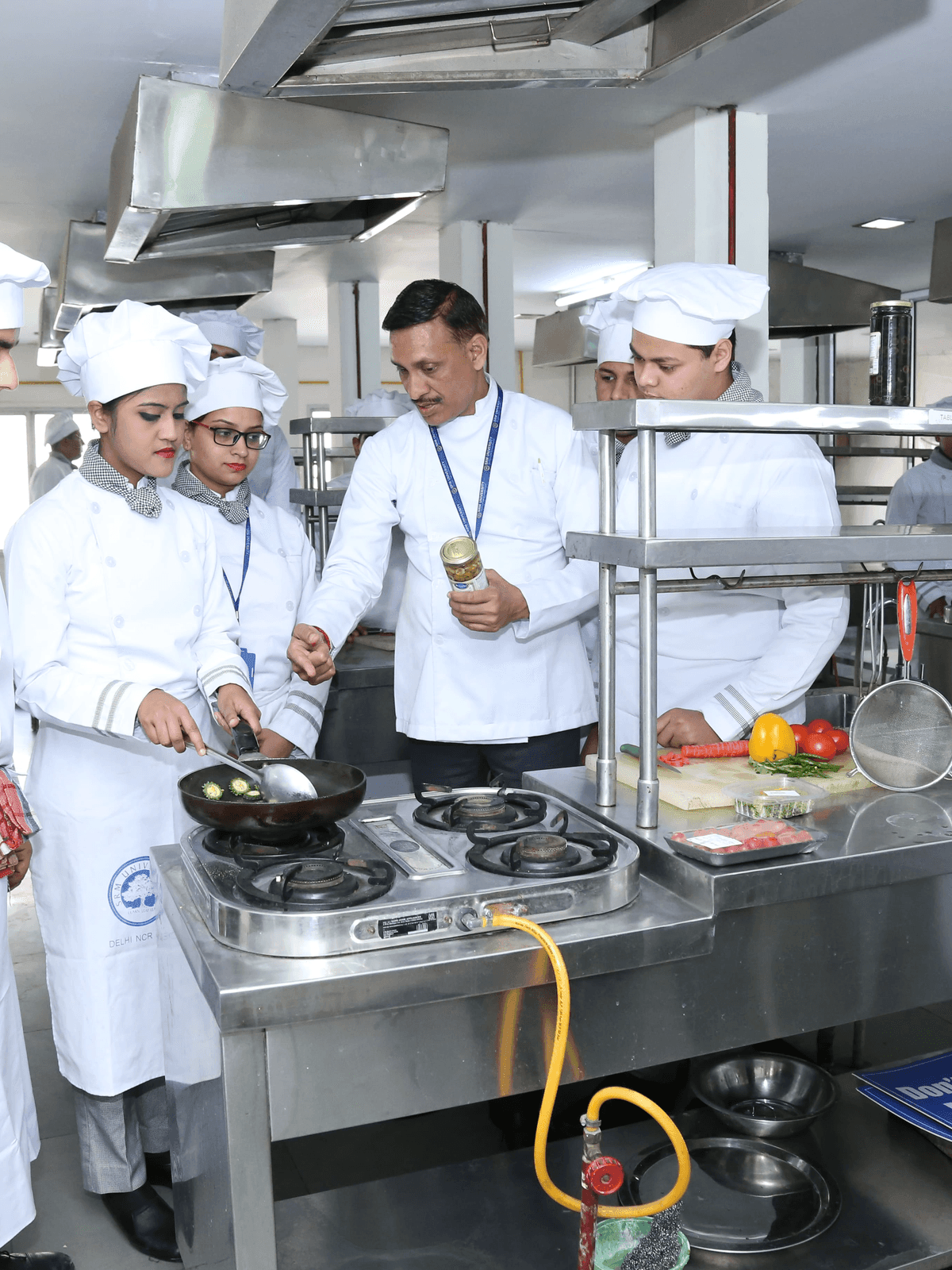 Chef instructor demonstrating culinary techniques to students